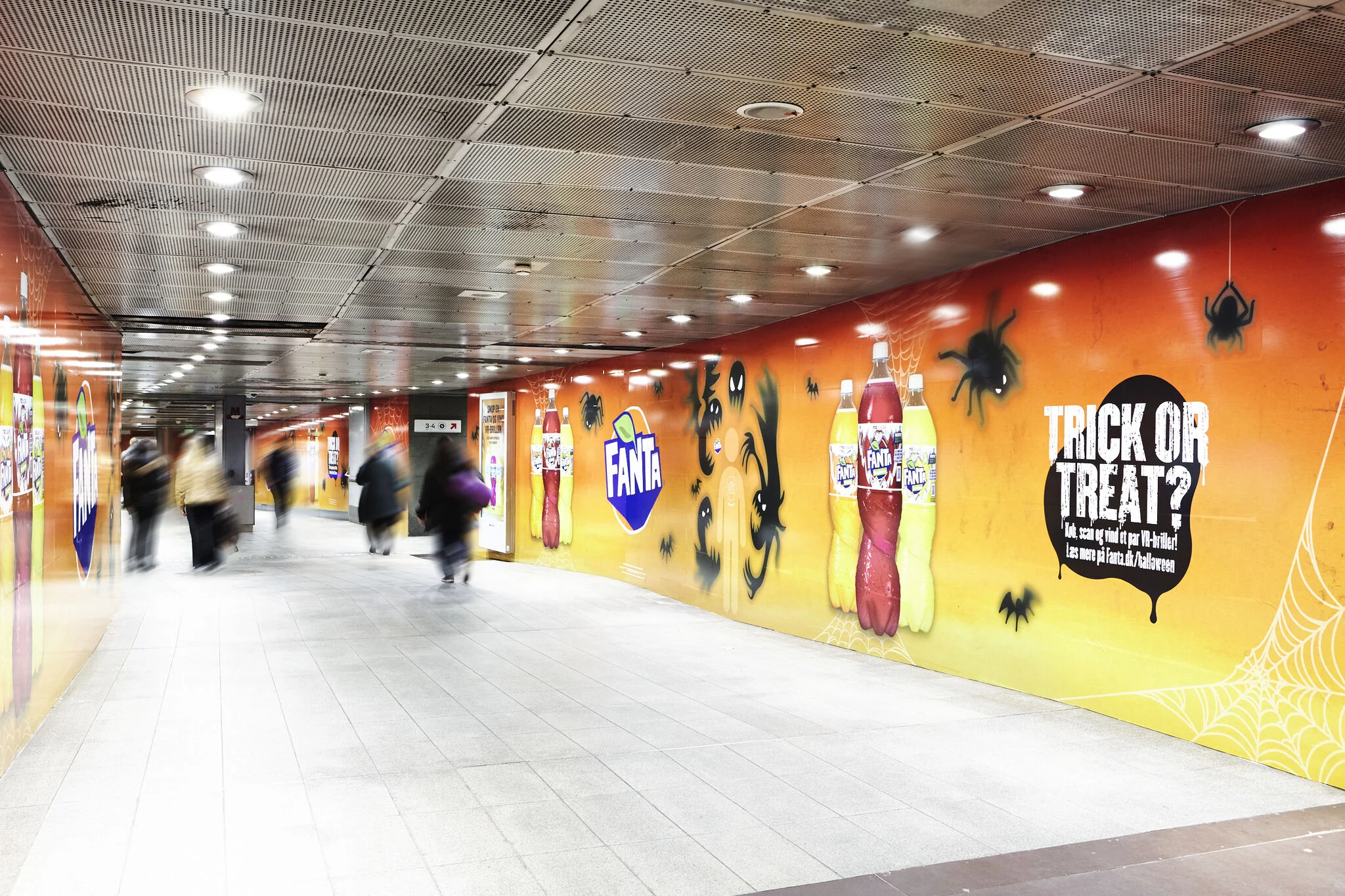 The takeover stretching along the curved passage with Trick or treat? artwork and spider webs