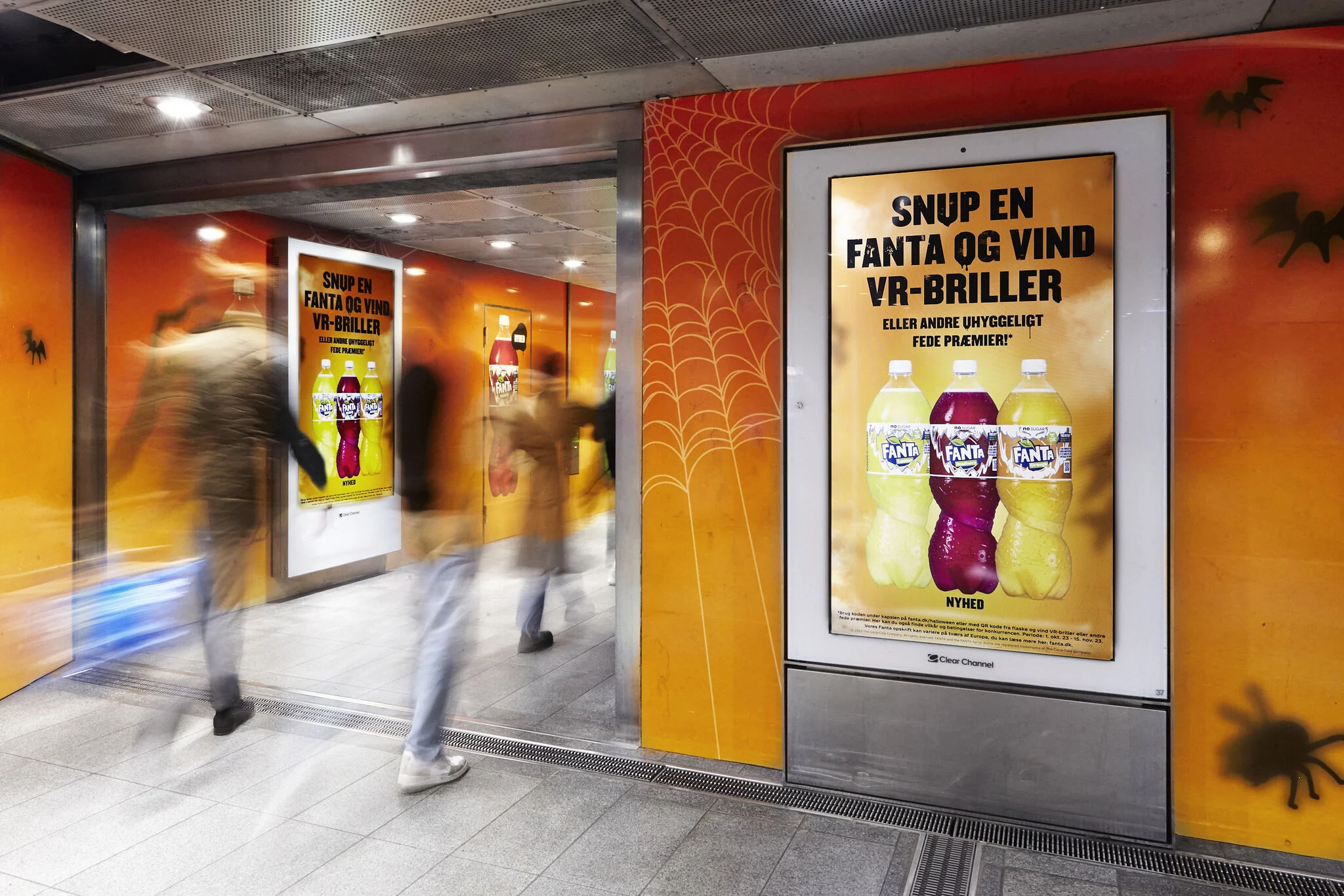 Digital Fanta screens set into the orange Halloween wallpaper with bats, spiders and webs
