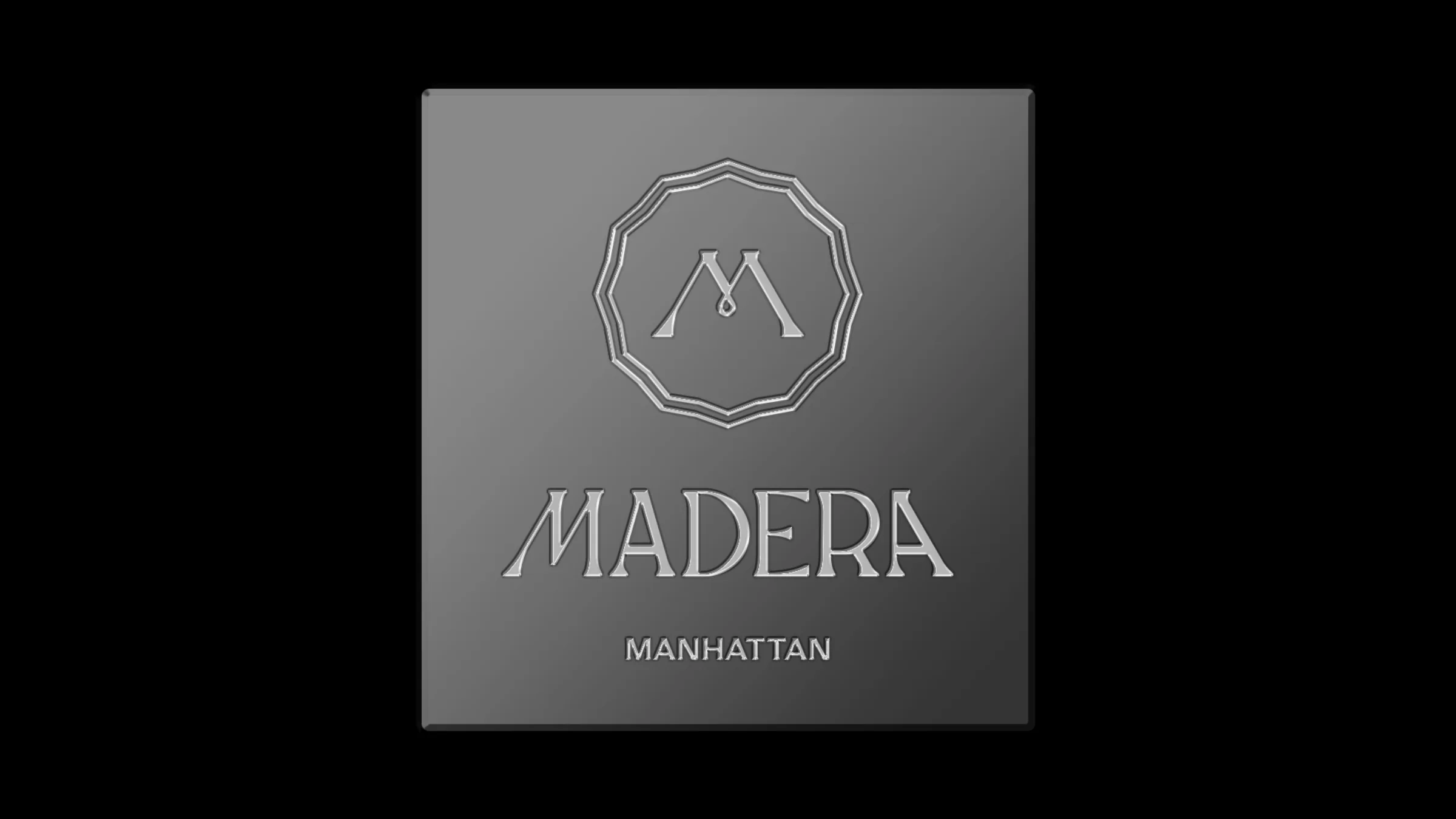 Madera seal and wordmark embossed on a brushed metal label